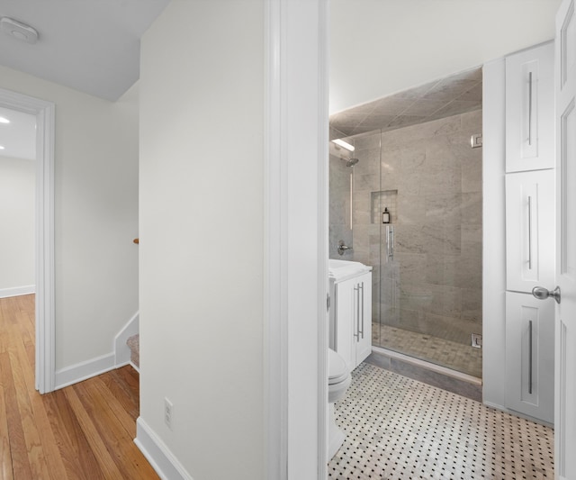 1015 Lincoln Ave, Ann Arbor, MI 48104 - full bathroom with a shower stall, toilet, vanity, baseboards, and wood finished floors