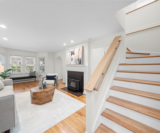 1015 Lincoln Ave, Ann Arbor, MI 48104 - living area with a wood stove, stairs, recessed lighting, wood finished floors, and a baseboard heating unit