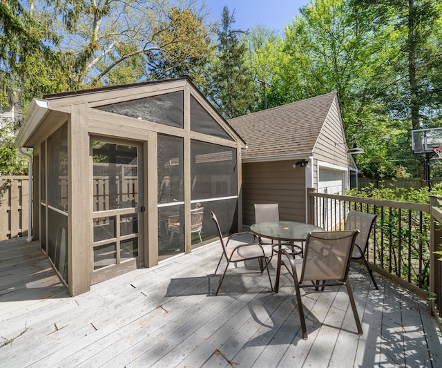 1015 Lincoln Ave, Ann Arbor, MI 48104 - deck with an outdoor structure, a sunroom, outdoor dining area, and a detached garage