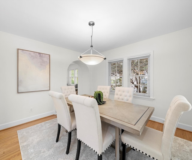 1015 Lincoln Ave, Ann Arbor, MI 48104 - dining room with arched walkways, light wood finished floors, and baseboards