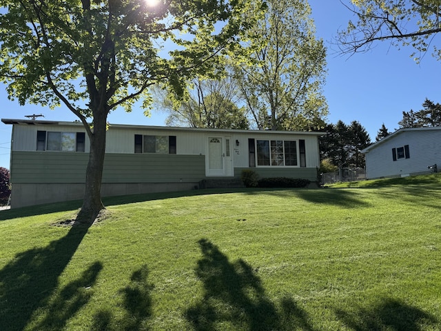 1235 Princeton St, Manistee, MI 49660 - view of front facade featuring a front yard and entry steps