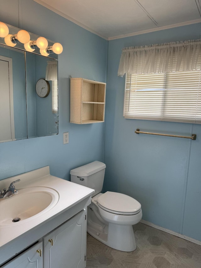 1235 Princeton St, Manistee, MI 49660 - bathroom with toilet, vanity, and ornamental molding