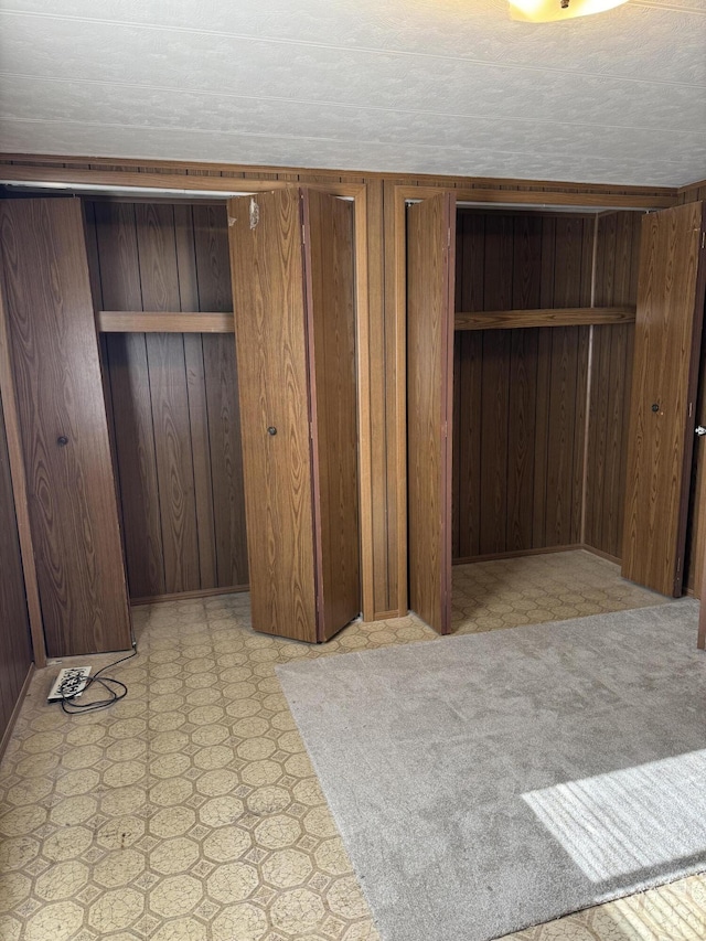 1235 Princeton St, Manistee, MI 49660 - unfurnished bedroom with wooden walls and light floors