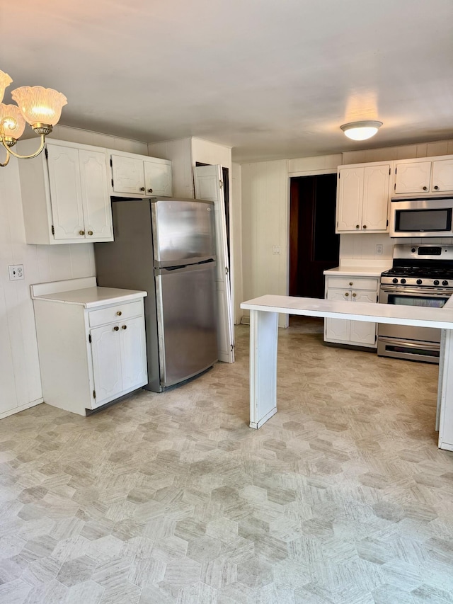 1235 Princeton St, Manistee, MI 49660 - kitchen with appliances with stainless steel finishes, white cabinetry, and light countertops