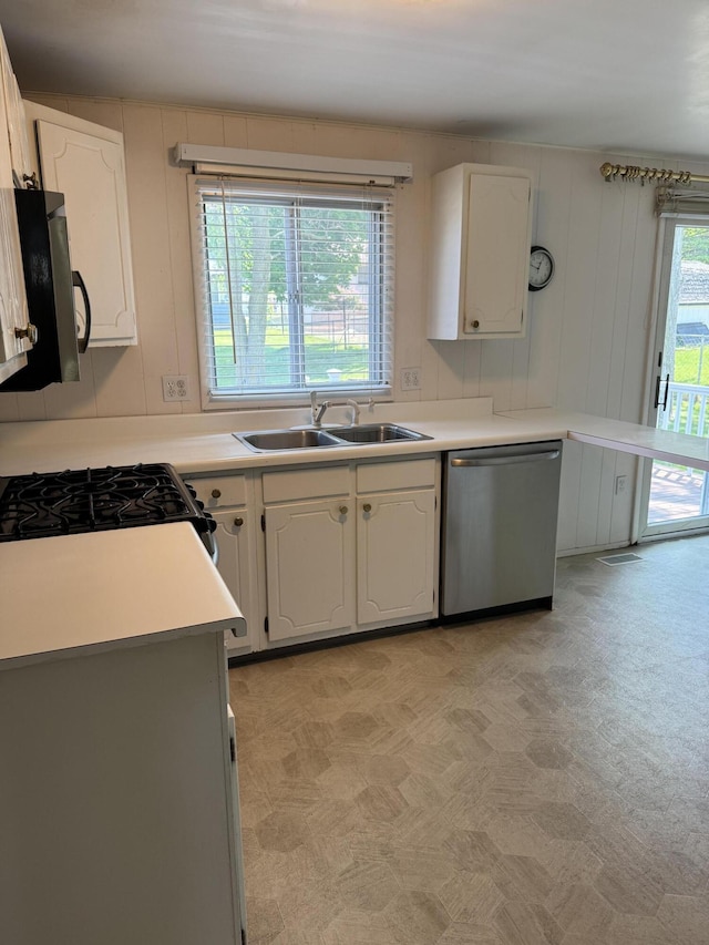 1235 Princeton St, Manistee, MI 49660 - kitchen featuring stainless steel appliances, a sink, white cabinets, and light countertops