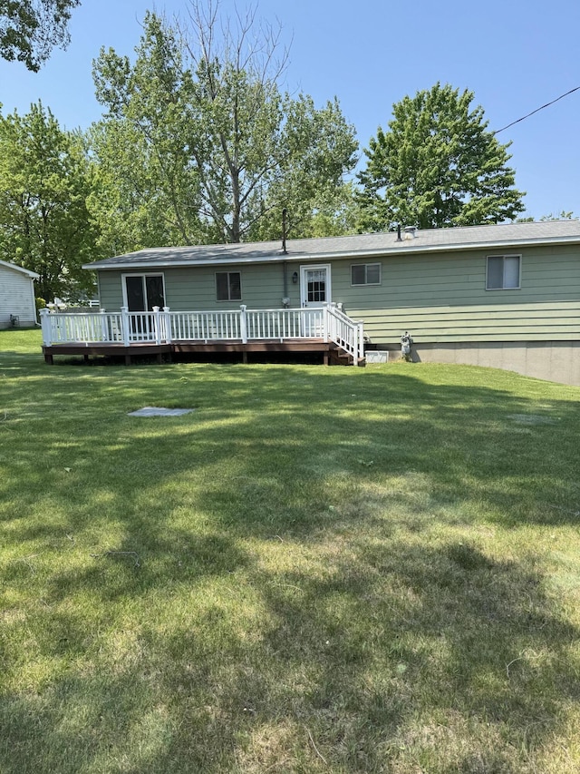 1235 Princeton St, Manistee, MI 49660 - back of property with a yard and a deck
