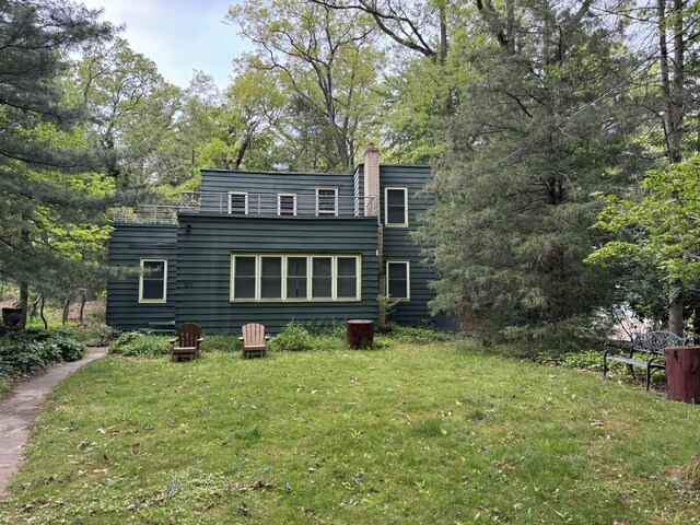 31 Mohawk Trl, New Buffalo, MI 49117 - back of house featuring a yard and a chimney
