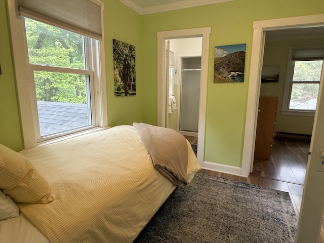 31 Mohawk Trl, New Buffalo, MI 49117 - bedroom featuring baseboard heating, ornamental molding, baseboards, and wood finished floors