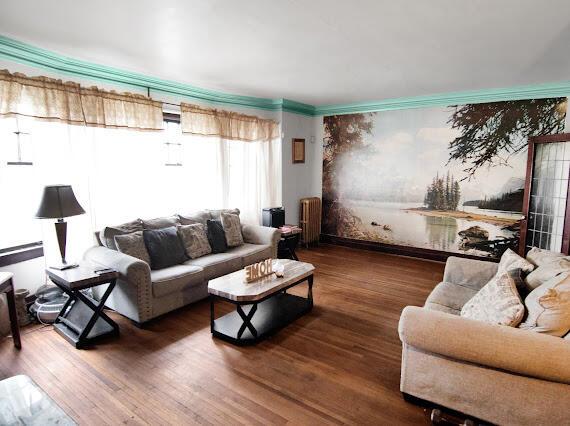 2041 Atkinson St, Detroit, MI 48206 - living room featuring radiator heating unit and wood finished floors