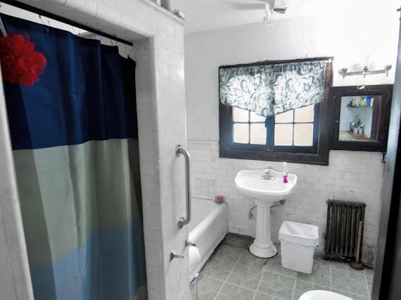 2041 Atkinson St, Detroit, MI 48206 - bathroom featuring radiator heating unit, tile walls, tile patterned flooring, toilet, and a wainscoted wall