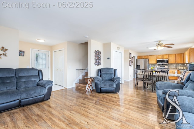 6420 Crestview Dr, Holly, MI 48442 - living room with light wood-style flooring, baseboards, and a ceiling fan