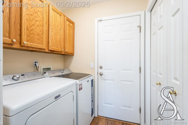 6420 Crestview Dr, Holly, MI 48442 - washroom with cabinet space, washing machine and dryer, and wood finished floors