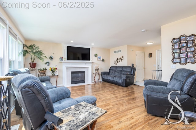 6420 Crestview Dr, Holly, MI 48442 - living room with light wood-style floors, a fireplace with flush hearth, and recessed lighting