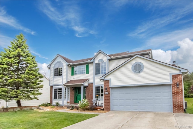 2864 Mystic Dr, Ann Arbor, MI 48103 - traditional home with brick siding, driveway, an attached garage, and a front lawn