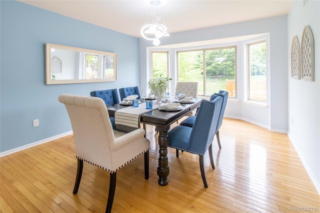 2864 Mystic Dr, Ann Arbor, MI 48103 - dining room featuring healthy amount of natural light, baseboards, light wood-style flooring, and a chandelier