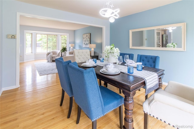 2864 Mystic Dr, Ann Arbor, MI 48103 - dining room with wood finished floors, a chandelier, and baseboards