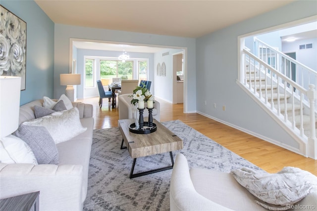 2864 Mystic Dr, Ann Arbor, MI 48103 - living area with wood finished floors, stairway, a chandelier, and baseboards