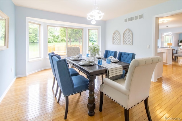 2864 Mystic Dr, Ann Arbor, MI 48103 - dining area with a chandelier, healthy amount of natural light, light wood-style flooring, and baseboards