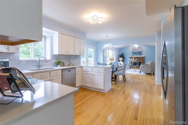 2864 Mystic Dr, Ann Arbor, MI 48103 - kitchen featuring appliances with stainless steel finishes, a sink, a peninsula, and healthy amount of natural light