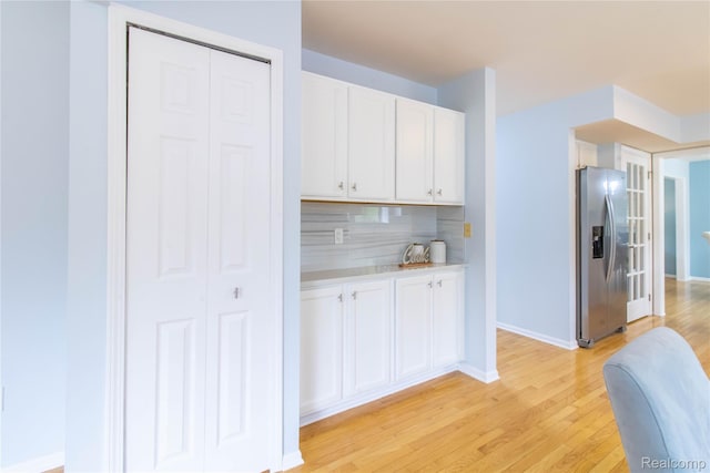 2864 Mystic Dr, Ann Arbor, MI 48103 - kitchen featuring stainless steel fridge with ice dispenser, white cabinetry, light wood-style floors, and light countertops