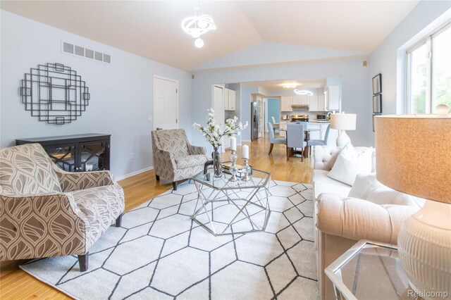 2864 Mystic Dr, Ann Arbor, MI 48103 - living area with light wood-type flooring, lofted ceiling, and baseboards