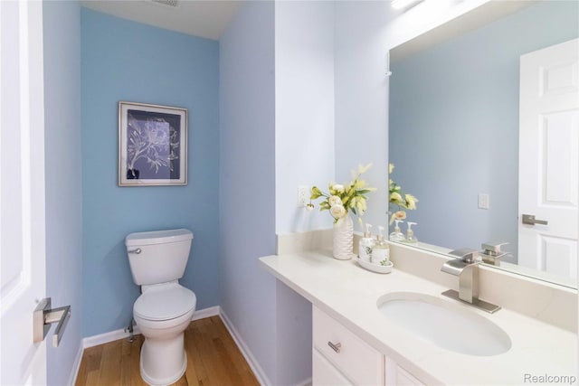 2864 Mystic Dr, Ann Arbor, MI 48103 - bathroom featuring wood finished floors, vanity, toilet, and baseboards