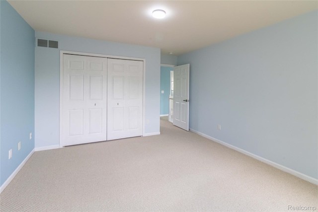 2864 Mystic Dr, Ann Arbor, MI 48103 - unfurnished bedroom featuring light carpet, a closet, and baseboards
