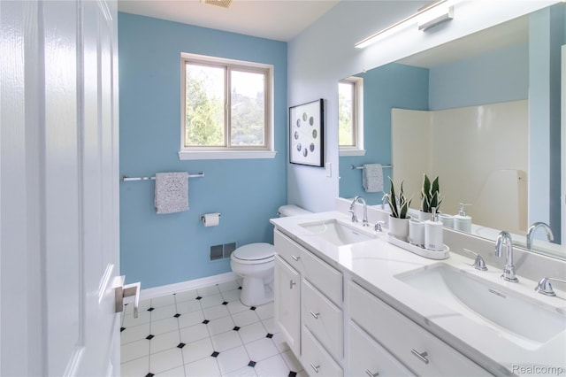 2864 Mystic Dr, Ann Arbor, MI 48103 - bathroom featuring double vanity, toilet, baseboards, a shower, and tile patterned floors