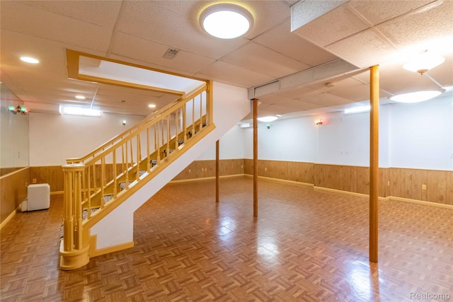2864 Mystic Dr, Ann Arbor, MI 48103 - finished below grade area featuring wood walls, a wainscoted wall, a drop ceiling, stairway, and baseboards