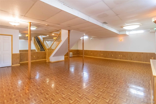 2864 Mystic Dr, Ann Arbor, MI 48103 - finished below grade area featuring a wainscoted wall, wood walls, stairway, a paneled ceiling, and baseboards