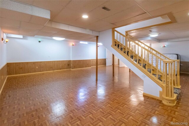 2864 Mystic Dr, Ann Arbor, MI 48103 - finished basement featuring a drop ceiling, wainscoting, stairway, wooden walls, and baseboards