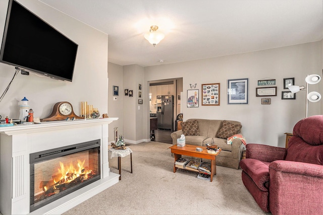 510 Cedar St, Paw Paw, MI 49079 - living room with carpet floors, a glass covered fireplace, and baseboards