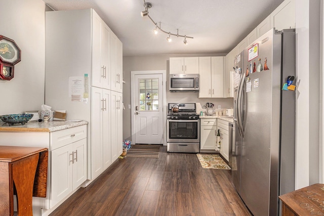 510 Cedar St, Paw Paw, MI 49079 - kitchen with stainless steel appliances, dark wood-type flooring, light countertops, and white cabinetry