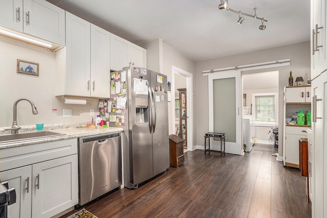 510 Cedar St, Paw Paw, MI 49079 - kitchen with stainless steel appliances, a sink, dark wood finished floors, washer / dryer, and white cabinetry