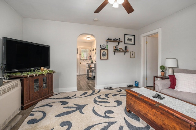 510 Cedar St, Paw Paw, MI 49079 - living room with arched walkways, ceiling fan, wood finished floors, and baseboards