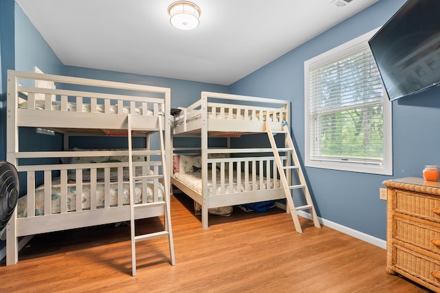 92282 Entrance Dr, Lawton, MI 49065 - bedroom with wood finished floors, multiple windows, and baseboards