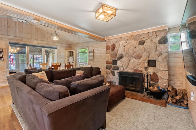 92282 Entrance Dr, Lawton, MI 49065 - living room featuring wooden walls, lofted ceiling, healthy amount of natural light, a stone fireplace, and wood finished floors