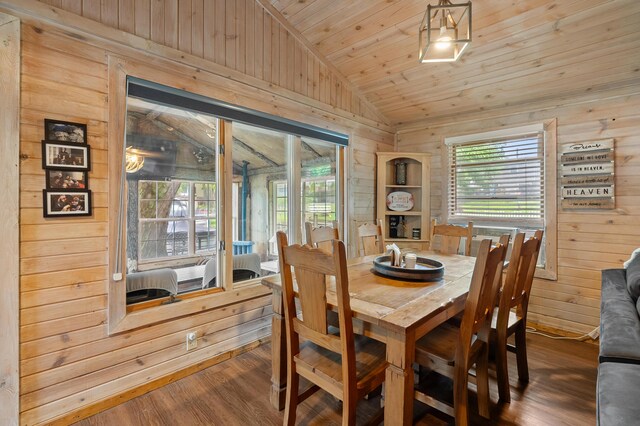 92282 Entrance Dr, Lawton, MI 49065 - dining room featuring lofted ceiling, wooden walls, wood finished floors, and wooden ceiling