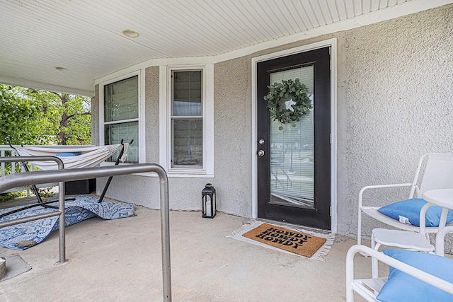 128 S Main St, Lawton, MI 49065 - view of exterior entry with stucco siding and covered porch