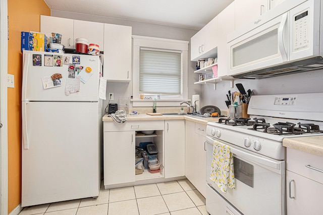 128 S Main St, Lawton, MI 49065 - kitchen featuring white appliances, light countertops, light tile patterned floors, and white cabinetry