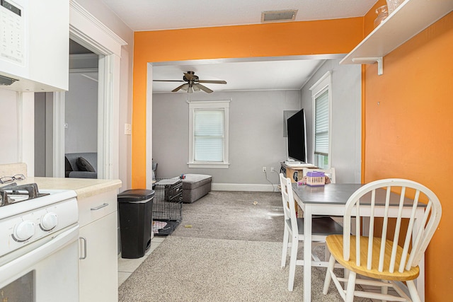 128 S Main St, Lawton, MI 49065 - kitchen with a ceiling fan, white cabinetry, white appliances, and plenty of natural light