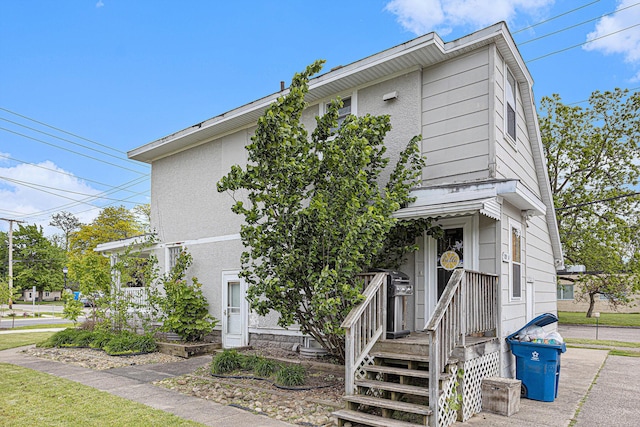 128 S Main St, Lawton, MI 49065 - view of front of home with stucco siding