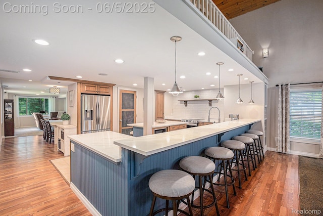 6080 Waldon Rd, Clarkston, MI 48346 - kitchen featuring appliances with stainless steel finishes, light wood-type flooring, a kitchen breakfast bar, plenty of natural light, and recessed lighting