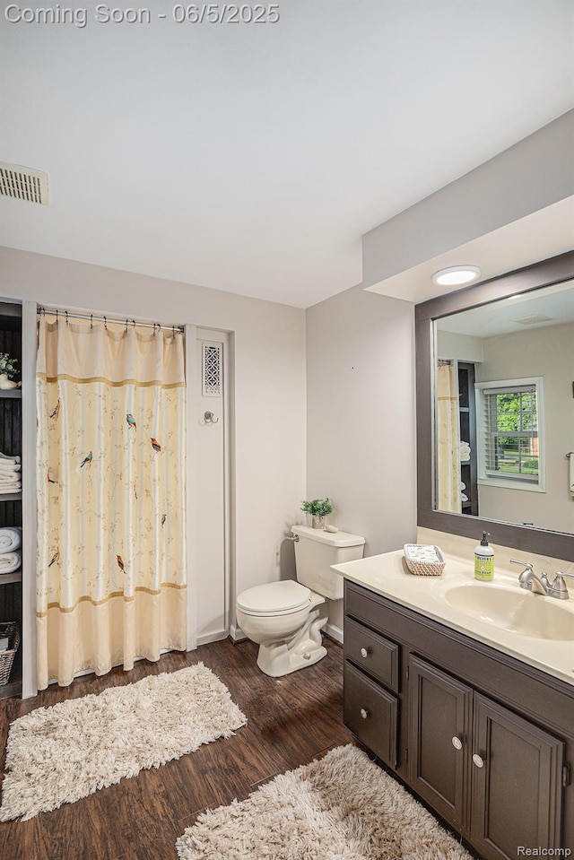 6080 Waldon Rd, Clarkston, MI 48346 - full bath with toilet, vanity, and wood finished floors