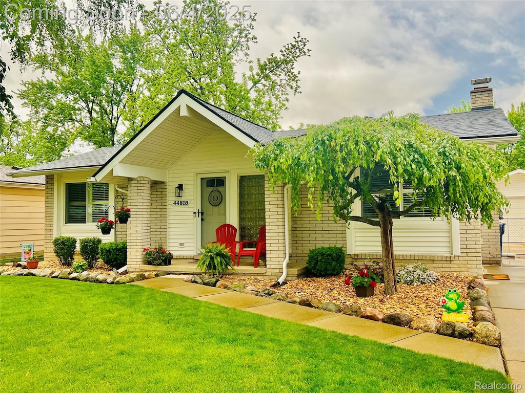44818 Whitman Ave, Canton, MI 48187 - view of front of home with brick siding, a front lawn, and roof with shingles