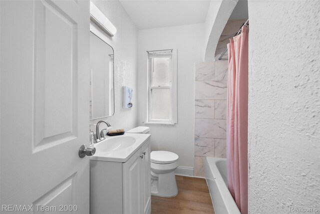 5935 Devonshire Rd, Dearborn, MI 48224 - full bath with vanity, toilet, wood finished floors, and shower / bath combo with shower curtain
