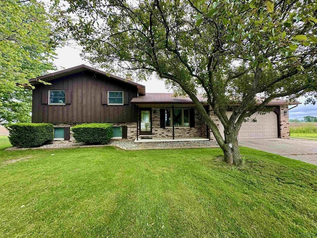 19379 Lincoln Rd, New Lothrop, MI 48460 - split level home with an attached garage, driveway, brick siding, and a front yard