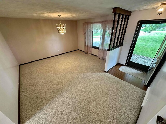 19379 Lincoln Rd, New Lothrop, MI 48460 - foyer with a chandelier, wood finished floors, and baseboards