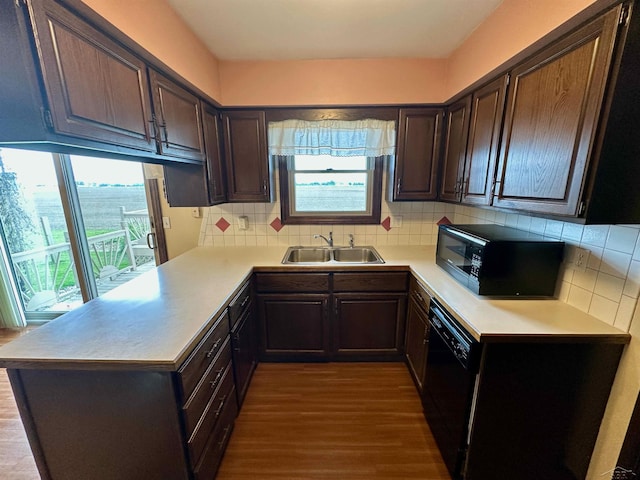 19379 Lincoln Rd, New Lothrop, MI 48460 - kitchen with black appliances, a sink, plenty of natural light, and dark wood finished floors