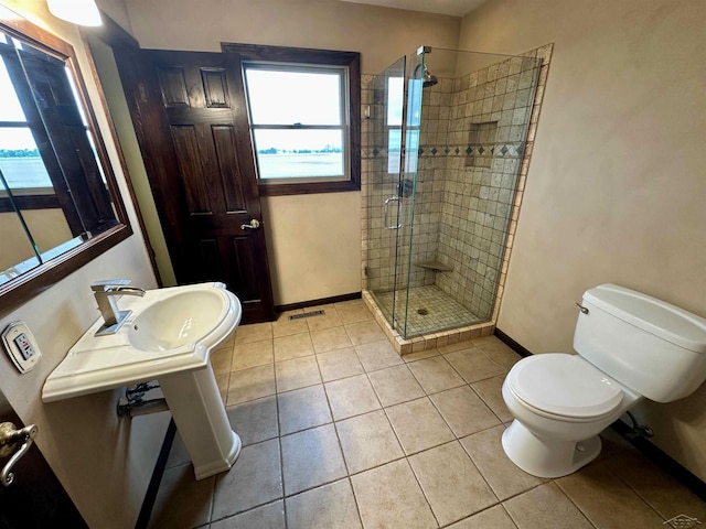 19379 Lincoln Rd, New Lothrop, MI 48460 - bathroom with baseboards, a shower stall, toilet, and tile patterned flooring